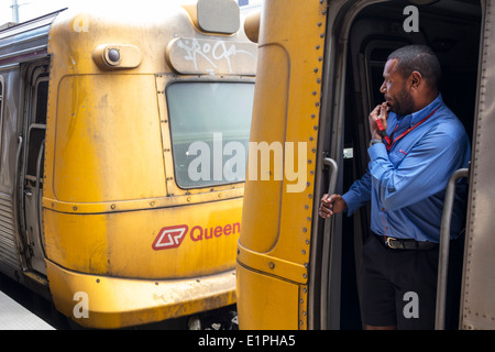 Brisbane Australia,South Brisbane Station,Queensland Rail City network,train,TransLink,Black man men male,employee worker workers working staff,engine Stock Photo