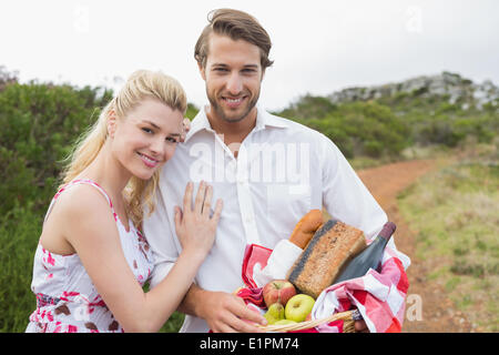 Cute couple going for a picnic smiling at camera Stock Photo