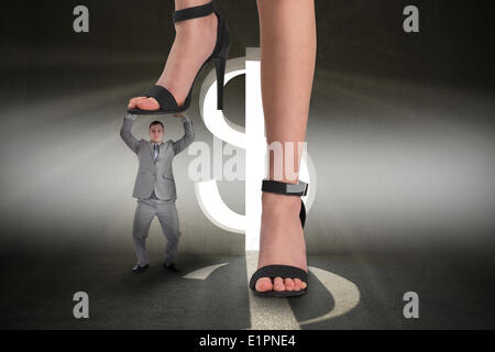 Composite image of female feet in black sandals stepping on tiny businessman Stock Photo