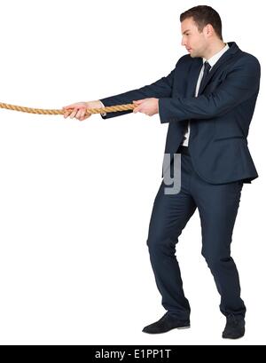 Young businessman pulling a rope Stock Photo