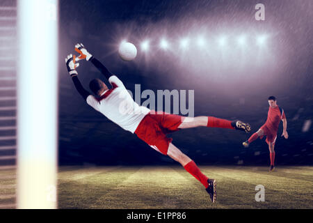 Composite image of fit goal keeper jumping up Stock Photo