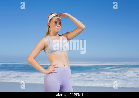 Sporty focused blonde on the beach Stock Photo