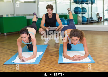 Fit women working out together in studio with trainer Stock Photo
