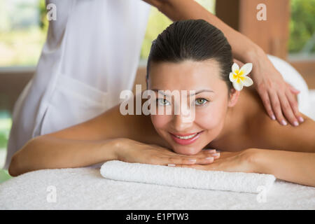 Brunette enjoying a peaceful massage smiling at camera Stock Photo