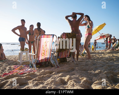 SALVADOR, BRAZIL - OCTOBER 13, 2013: Residents relaxing in the sunset afternoon on Porto da Barra beach. Stock Photo