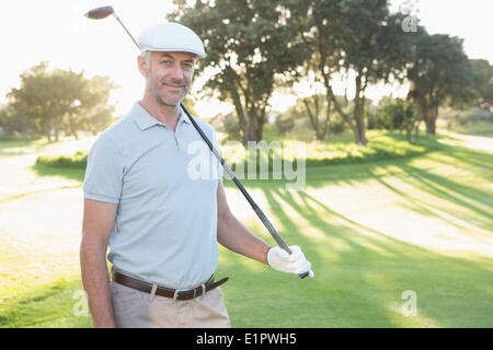 Smiling handsome golfer looking at camera Stock Photo