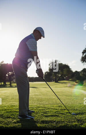 Golfer teeing off for the day Stock Photo