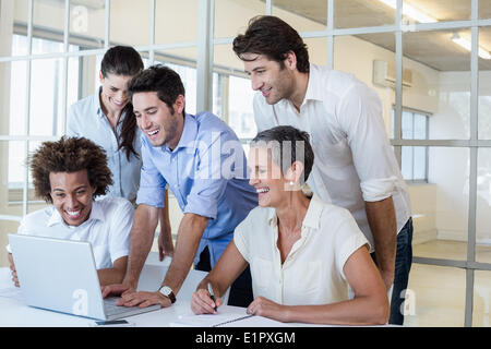 Casual business team having a meeting using laptop Stock Photo
