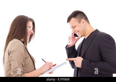satisfied and happy businessman on the phone and his secretary writing down notes Stock Photo