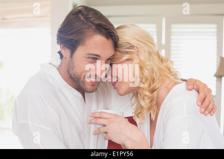 Couple having breakfast in their bathrobes Stock Photo