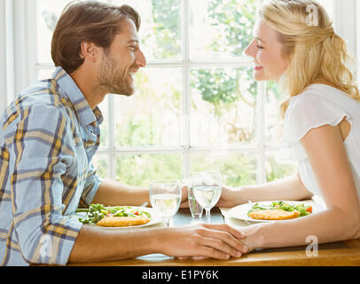 Happy couple enjoying a meal together Stock Photo