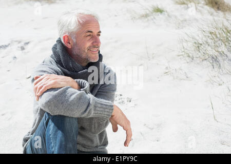 Attractive man smiling on the beach in scarf Stock Photo