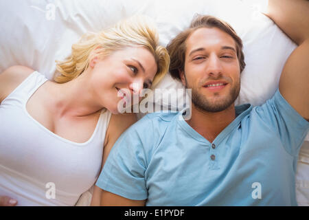 Happy couple relaxing on bed Stock Photo