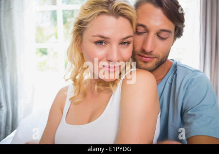 Happy couple relaxing on bed Stock Photo