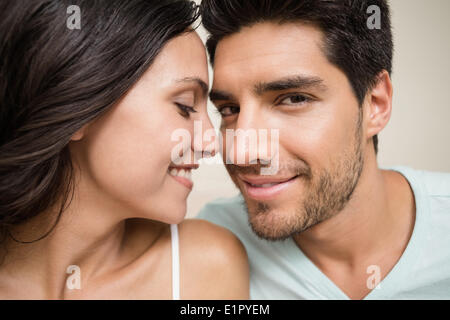 Attractive couple sitting on bed Stock Photo