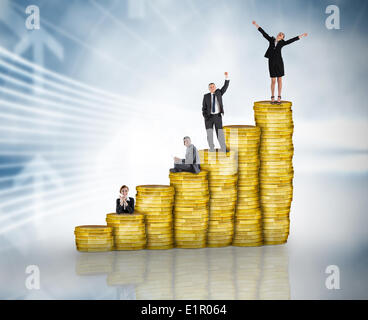 Composite image of business people on pile of coins Stock Photo