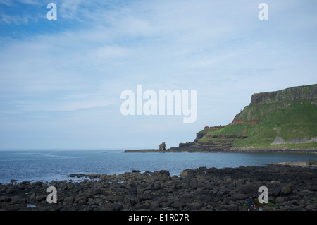 Giant's Causeway, a world heritage site. Showing stack and 'Chimney stacks' in the distance on northern coast, Northern Ireland Stock Photo