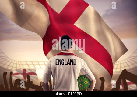 Composite image of england football player holding ball Stock Photo