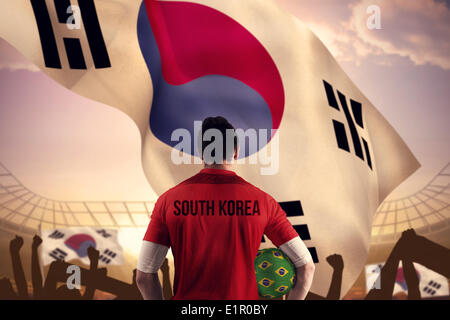 Composite image of south korea football player holding ball Stock Photo