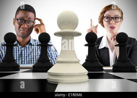 Composite image of business people playing chess Stock Photo