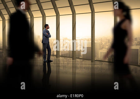 Composite image of business people walking in a blur Stock Photo