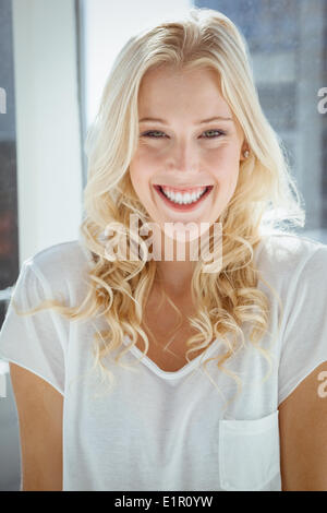 Pretty blonde smiling at camera at home in the garden Stock Photo - Alamy