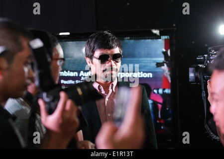 Manila, Philippines. 9th June, 2014. Makati, Philippines - Filipino boxing champion Manny Pacquiao arrives at a press conference in Makati, east of Manila on June 9, 2014. Manny Pacquaio was appointed as head coach of KIA, a new team joining the local professional basketball league in the Philippines. © Mark Cristino/NurPhoto/ZUMAPRESS.com/Alamy Live News Stock Photo