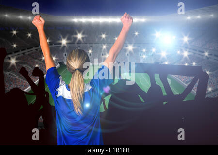 Composite image of cheering football fan in blue Stock Photo