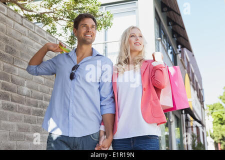 Stylish young couple walking with shopping bags Stock Photo