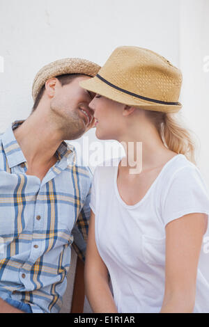 Young hip couple sitting on bench Stock Photo