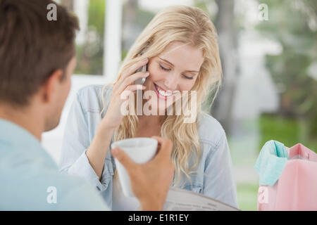 Cute couple relaxing after shopping trip in cafe Stock Photo