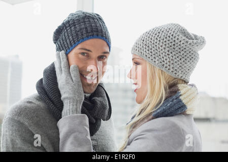 Cute couple in warm clothing hugging woman smiling at camera Stock ...