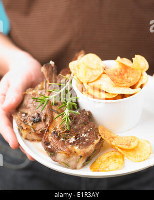 Grilled lamb chops with rosemary and crisps Stock Photo