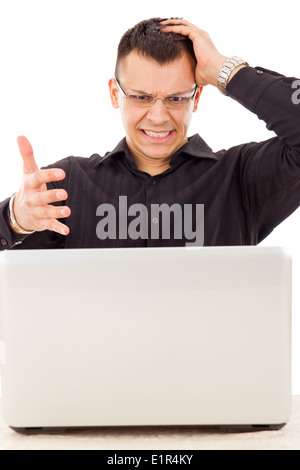stressed casual man with glasses in black shirt looking at laptop Stock Photo