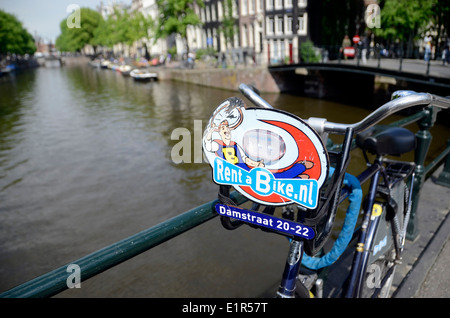 Rental bike on a canal bridge in central Amsterdam Holland Stock Photo