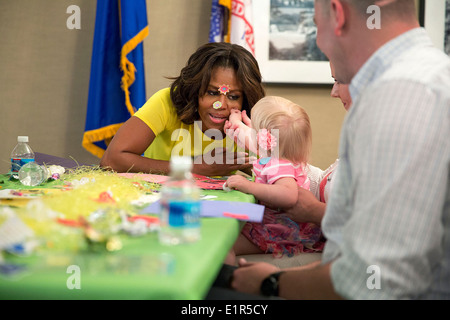 US First Lady Michelle Obama visits with military families working on crafts at Maryland Fisher House IV at Walter Reed National Military Medical Center April 14, 2014 in Bethesda, Maryland. Stock Photo