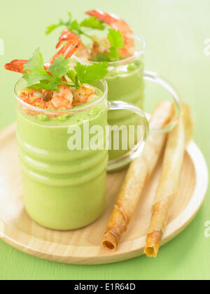 Cream of pea soup with shrimps Stock Photo