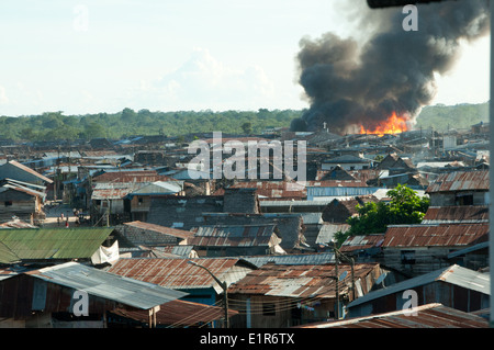 Smoke Plumes in the Sky as Fire Rages in the Belen district of Iquitos Peru Stock Photo