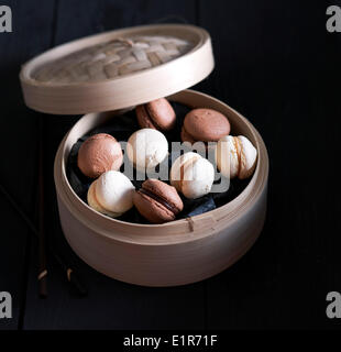Assorted macaroons in a bamboo basket Stock Photo