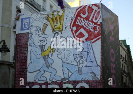 June 7, 2014 - Madrid, Spain - Protestors display a banner with a draw caricaturing King's Juan Carlos abdication on his son Prince Felipe similar to one that was published in the magazine ''El Jueves'' and later censored due to pressures from the royal house that caused the resignation of various cartoonists of that magazine, banner says ''Stop Borbones'', during a protest against the Spanish monarchy in Madrid, Spain, 7th jun 2014. Thousands of protestors marched through the streets of Madrid among other massive demonstrations all over Spain protesting against the Spanish monarchy and demand Stock Photo