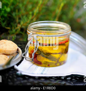 Jar of goat's cheese marinating in olive oil Stock Photo