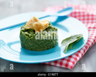 Mashed spinash with breaded fried fish Stock Photo