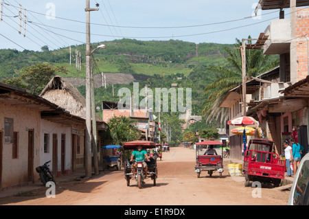 Dusty street with Mototaxi transport in Peruvian Amazon Town Stock Photo