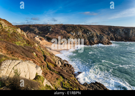 The sandy beach and high cliffs at Porthcurno near Penzance in Cornwall Stock Photo