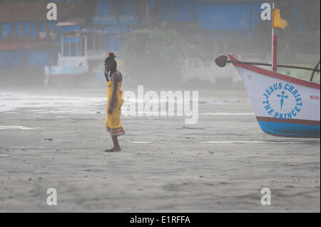 Arambol, Goa, India. 9th June, 2014. A tourist draws on a cigarette as the beginnings of the monsoon arrives at Arambol beach, north Goa, India. Credit:  Lee Thomas/Alamy Live News Stock Photo