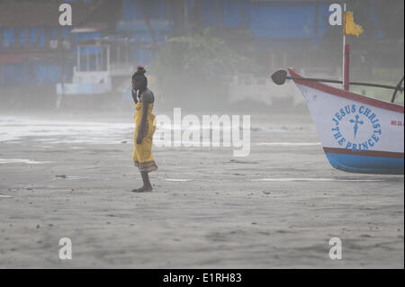 Arambol, Goa, India. 9th June, 2014. A tourist draws on a cigarette as the beginnings of the monsoon arrives at Arambol beach, north Goa, India. Credit:  Lee Thomas/ZUMA Wire/ZUMAPRESS.com/Alamy Live News Stock Photo