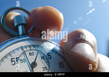 old silver chrome stopwatch with seconds and minute hands 5 second count down chronological timer glass dial buttons against Stock Photo