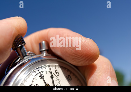 old silver chrome stopwatch with seconds and minute hands 5 second count down chronological timer glass dial buttons against Stock Photo