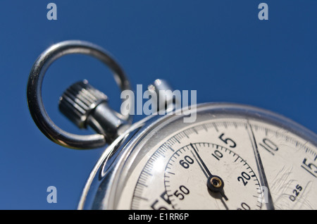 old silver chrome stopwatch with seconds and minute hands 5 second count down chronological timer glass dial buttons against Stock Photo