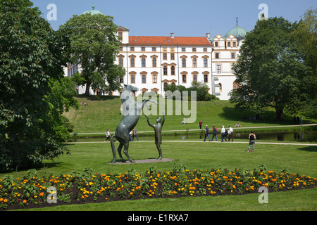 Ducal Palace with sculpture of a horse and trainer in the park at Celle Castle, Celle, Lower Saxony, Germany Stock Photo